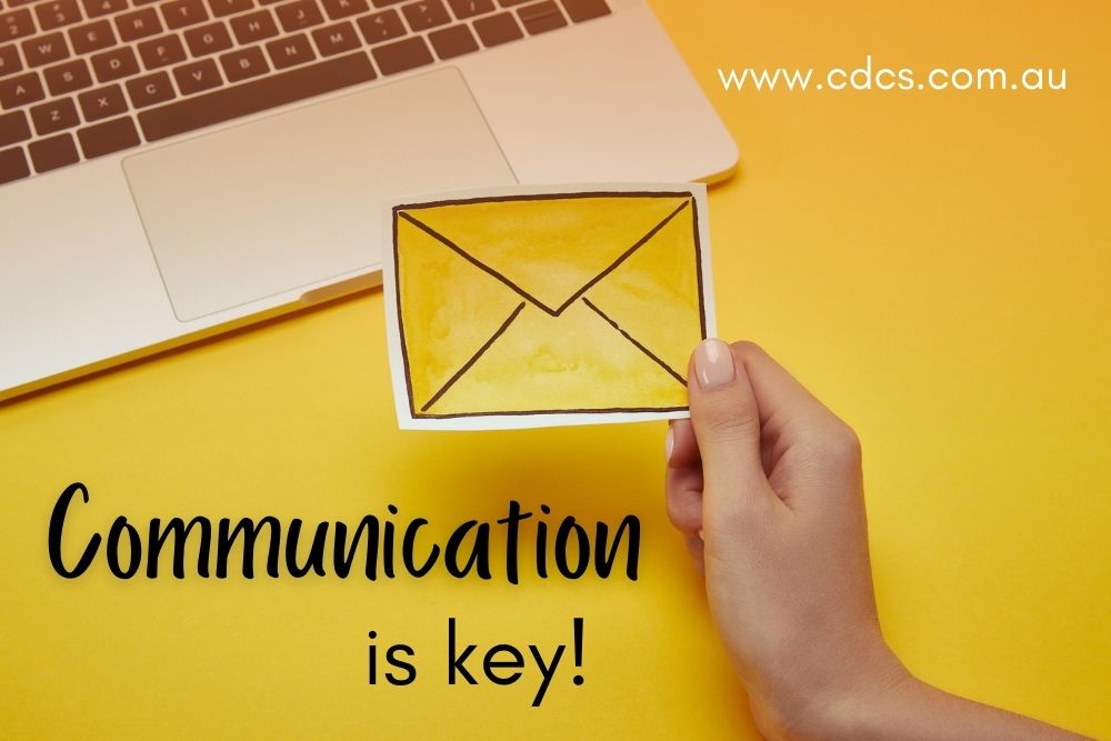 Laptop keyboard on yellow background with paper image of an envelope. Text says: "Communication is key!"