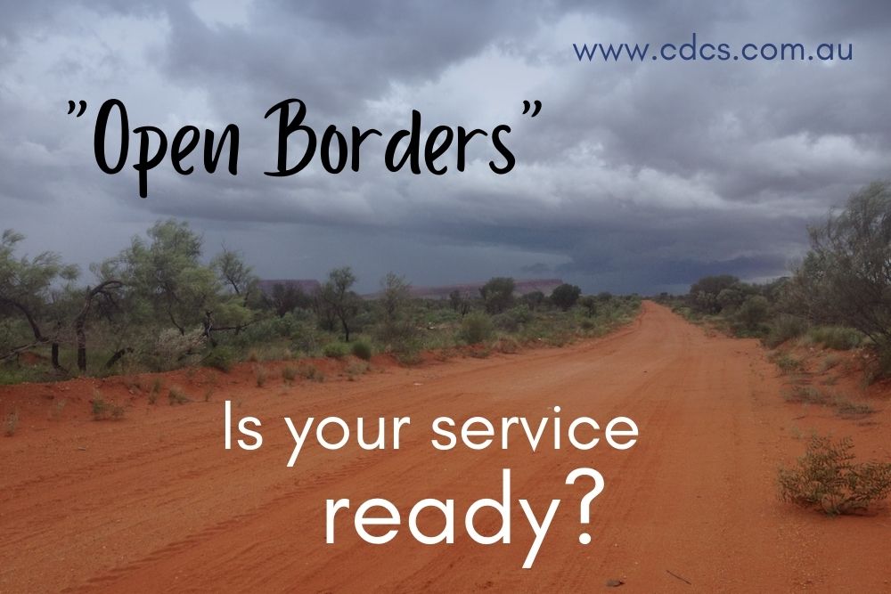 Red dirt road in the Australian outback with the words: "Open Borders. Is your service ready?"